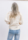 Back view of a cream yellow sweater with short puff sleeves, cable knit fabric and round neck. 