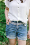 Model wearing 2 toned Judy blue shorts with a white top. 