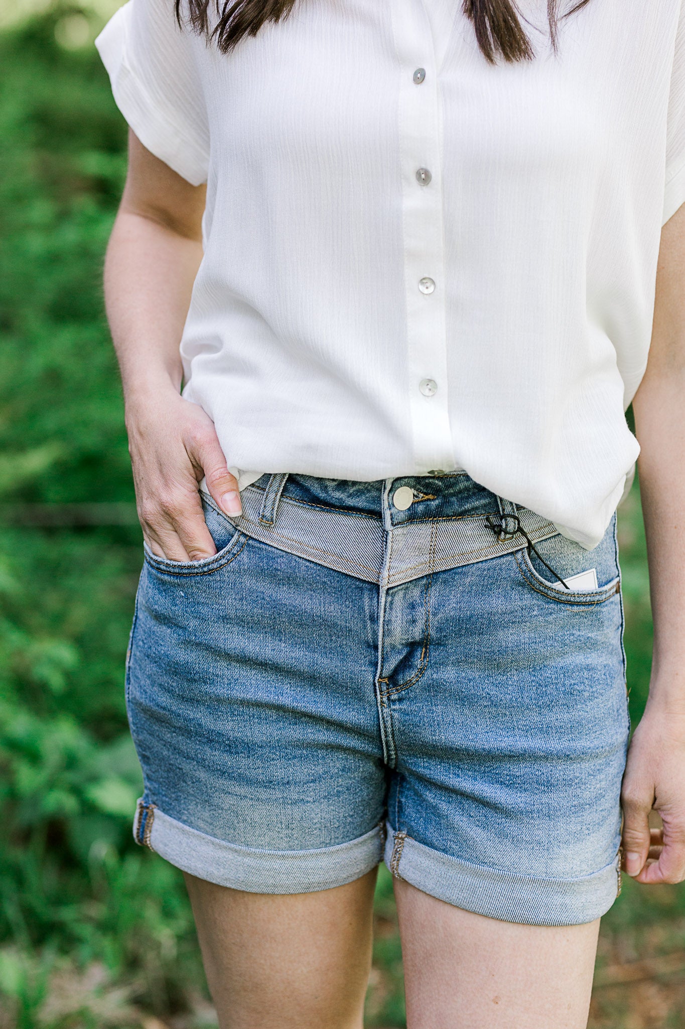 Model wearing 2 toned Judy blue shorts with a white top. 