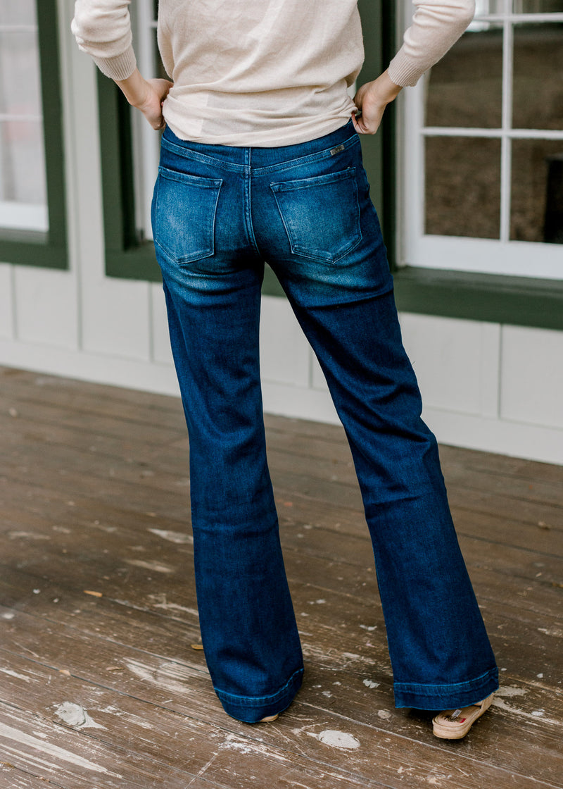 Back view of Model wearing wide leg, dark wash, jeans. 