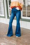 Model wearing flare, hi-rise jeans. 