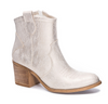 Gold tone bootie on white background.