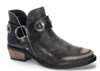 Black bootie with low stacked heel, decorative straps and o-ring accents