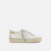 Side view of bone colored shoes with silver strings, a round toe and a star on the side.