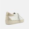Back view of bone colored shoes with silver strings, a round to and a star on the side. 