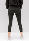 Back view of Model wearing black capri yoga pants. 