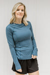 Blonde model wearing a fitted blue athleisure top