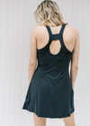 Back view of Blonde model wearing a navy romper workout dress.