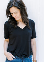 Close up of v-neck on black, bamboo, short sleeve top with a chest pocket. 