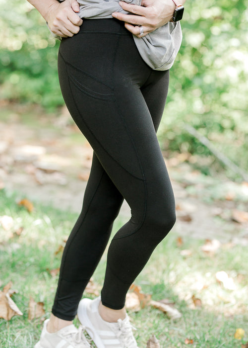 Black high waist leggings with sneakers.