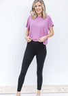 Blonde model wearing black v-waist leggings.