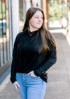 Brunette model wearing black hoodie. 