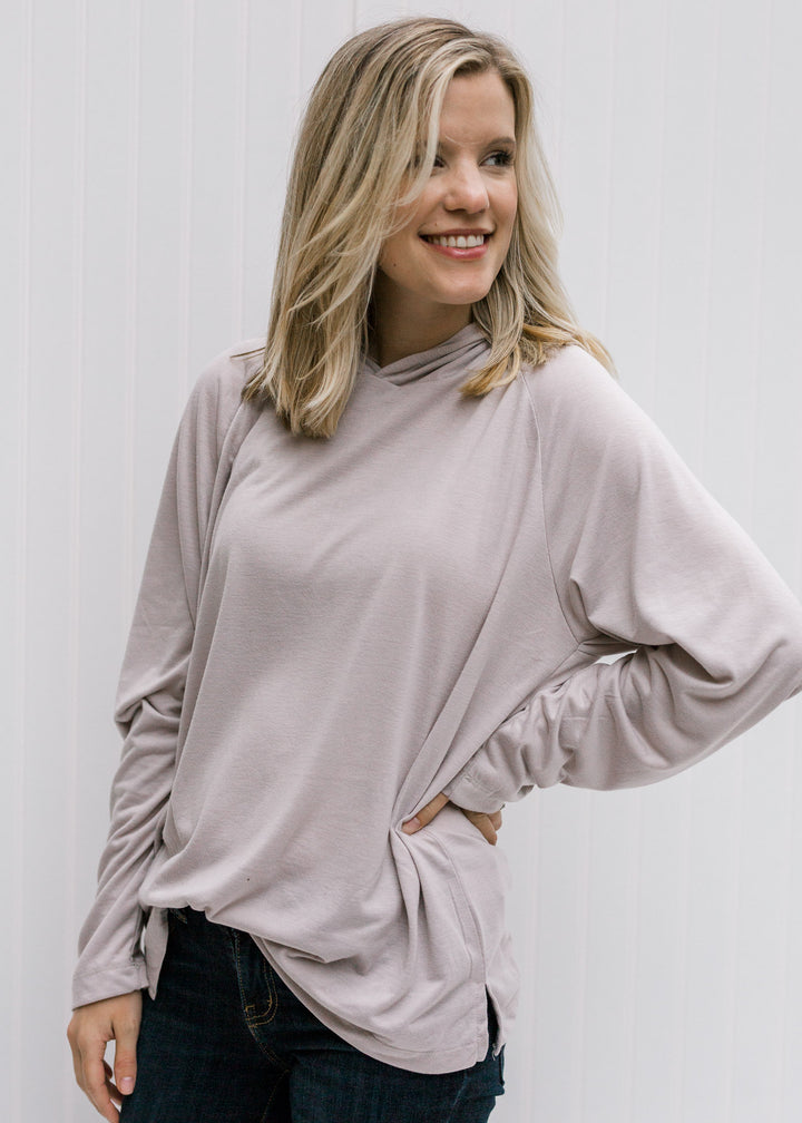 Blonde model wearing soft silvery taupe hoodie.