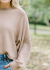 Close up view of bubble long sleeve on camel sweater.