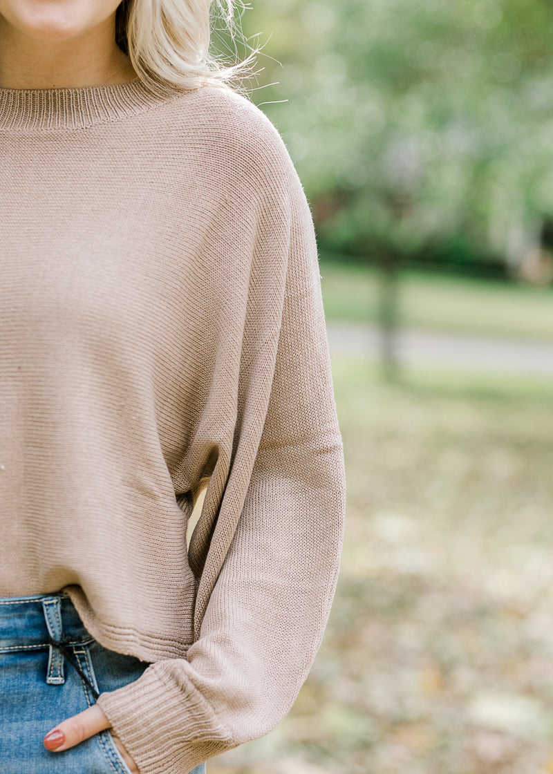 Close up view of bubble long sleeve on camel sweater.