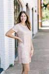 Brunette model wearing short sleeve sequin dress.