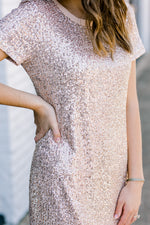 Close up view of bodice on champagne color, sequin dress.