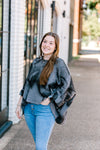 Brunette model wearing oversized mottled charcoal sweater