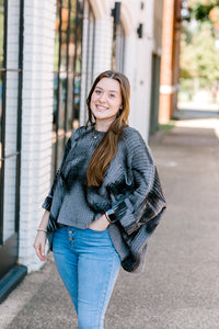 Brunette model wearing oversized mottled charcoal sweater