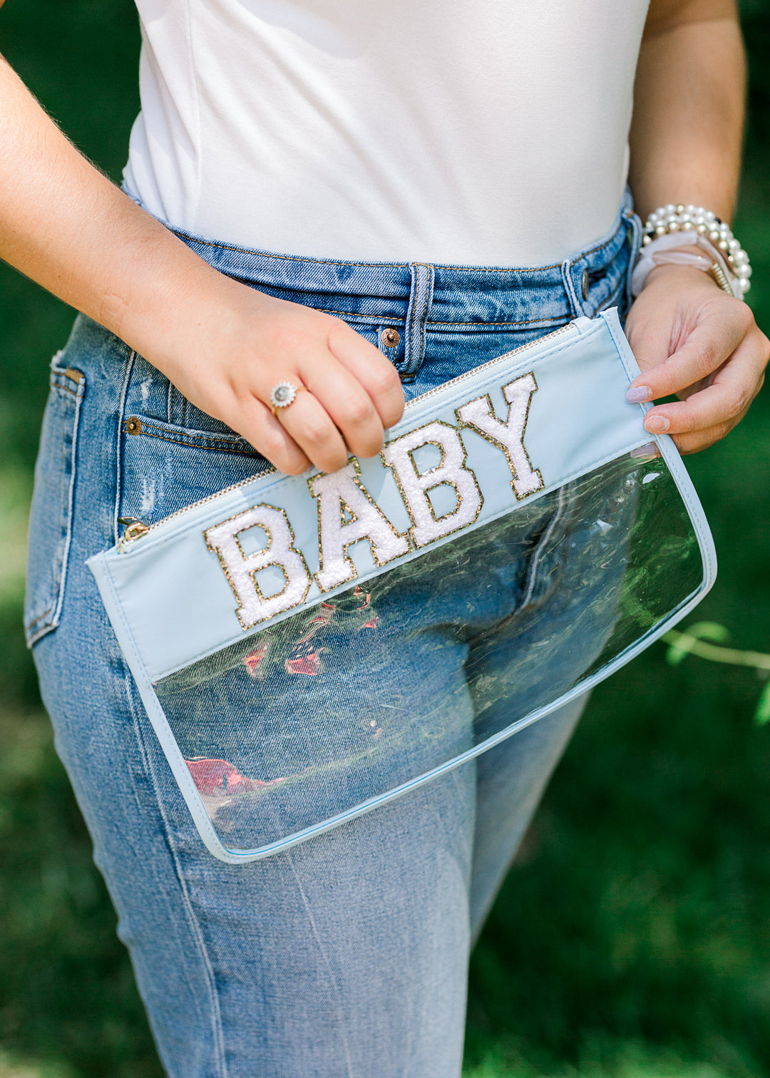 Clear zipper pouch with baby written across blue top. 