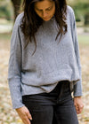 Brunette model wearing light blue sweater.
