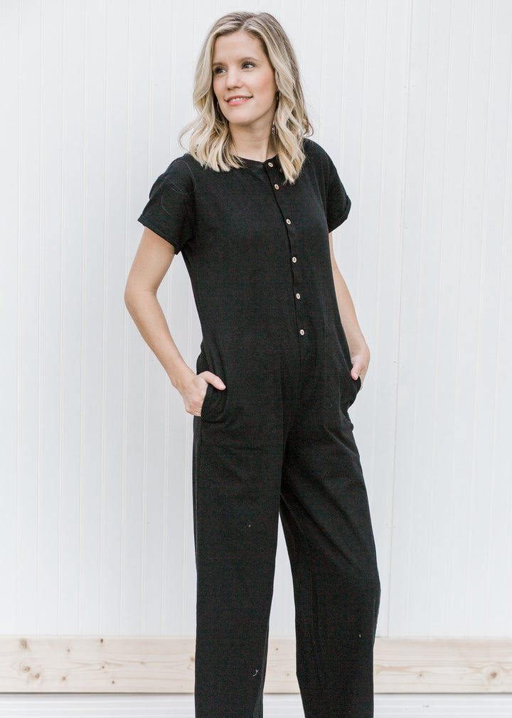 Blonde model wearing a black jumpsuit. 