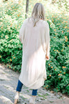 Back view of Blonde model wearing cream duster cardigan. 
