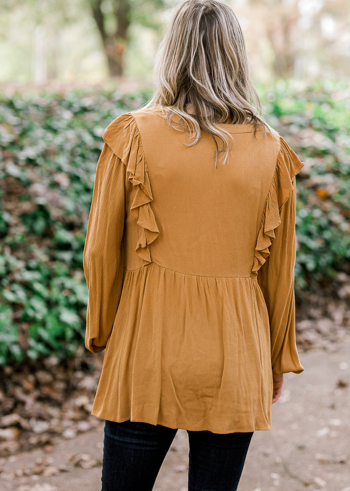 Back view of Blonde model wearing mustard blouse.