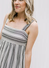Bodice view of Model wearing black and white midi dress with 2 inch straps.