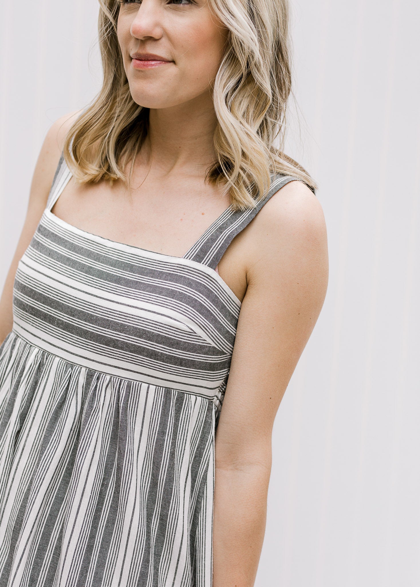 Bodice view of Model wearing black and white midi dress with 2 inch straps.
