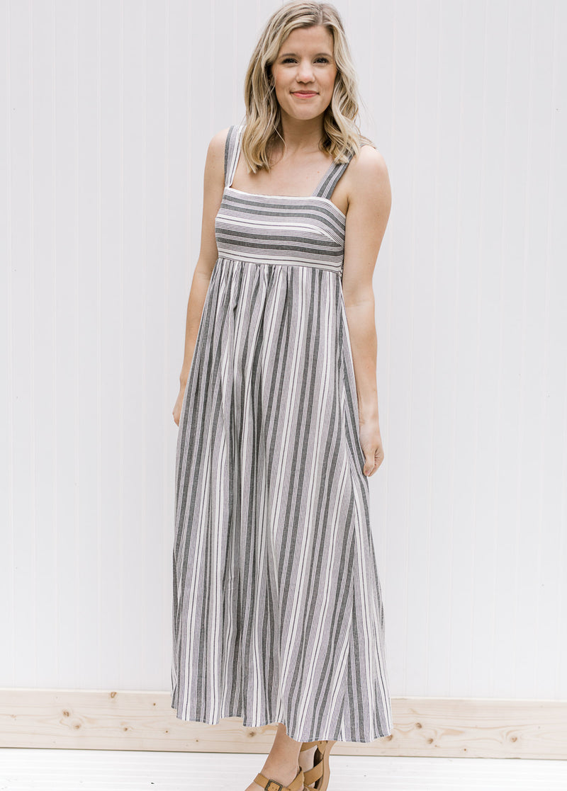 Model wearing black and white midi dress with 2 inch straps.