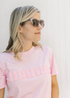 Side view of a model wearing marble sunglasses with a retro frame. 