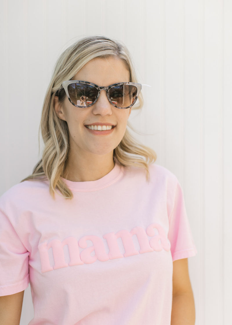 Model wearing marble sunglasses with a retro frame. 