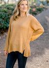 Blonde model wearing honey gold sweater. 
