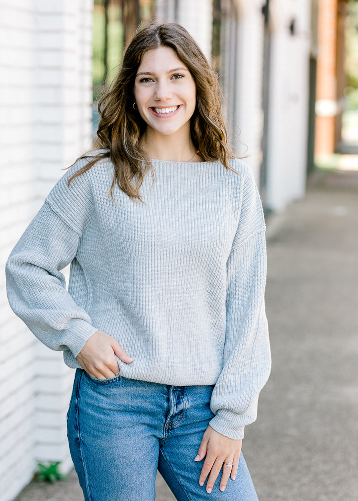 Brunette model with gray sweater.