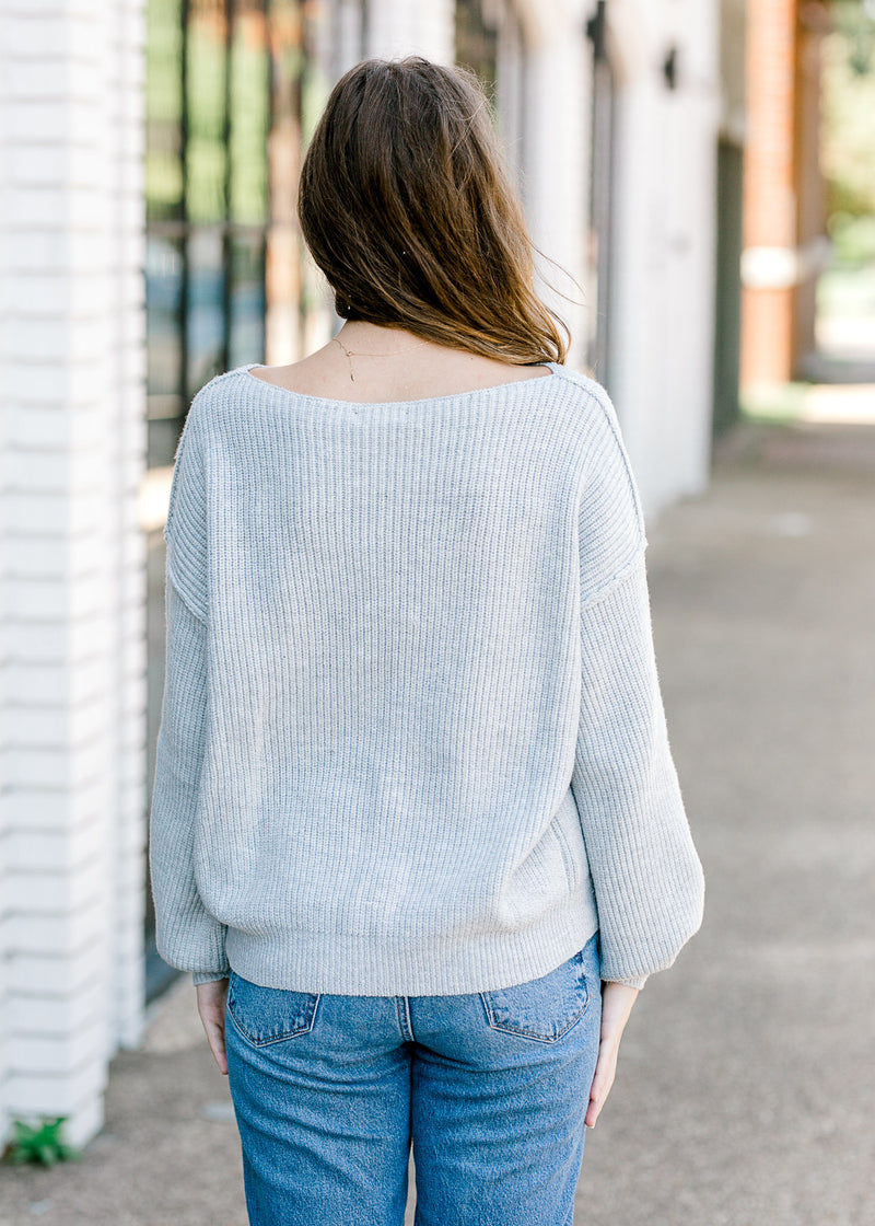 Back view of Brunette model with gray sweater.