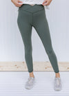 Model wearing gray sage leggings with v-waist.