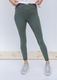 Model wearing gray sage leggings with v-waist.