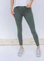 Sage gray leggings with stitching detail.