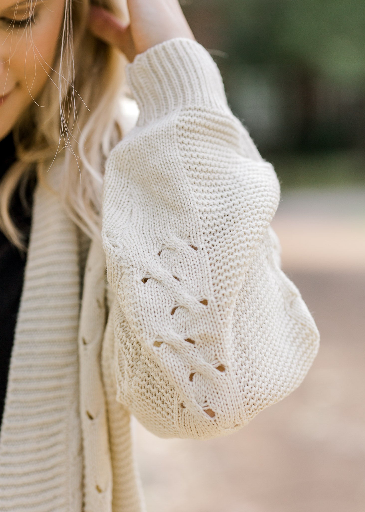 Detail view of stitching on cream cardigan