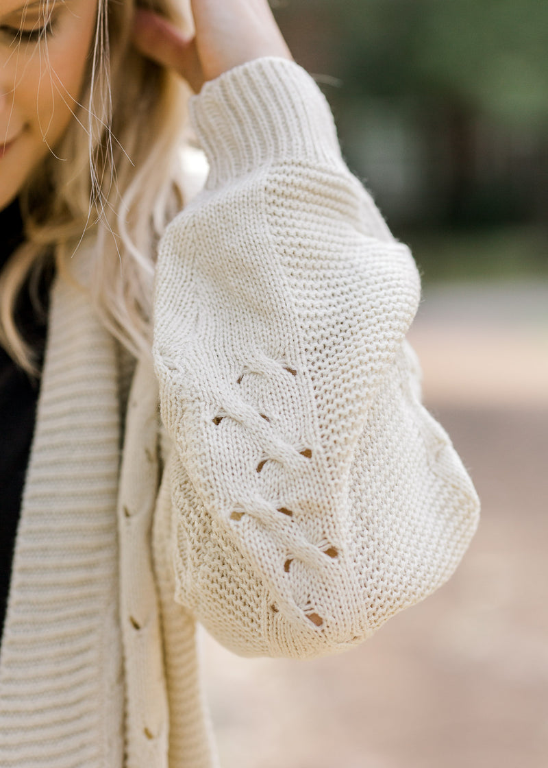 Detail view of stitching on cream cardigan