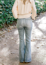 Back view of blonde model wearing hi-rise flair jeans.