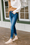 Model wearing double fray hem skinny jeans.