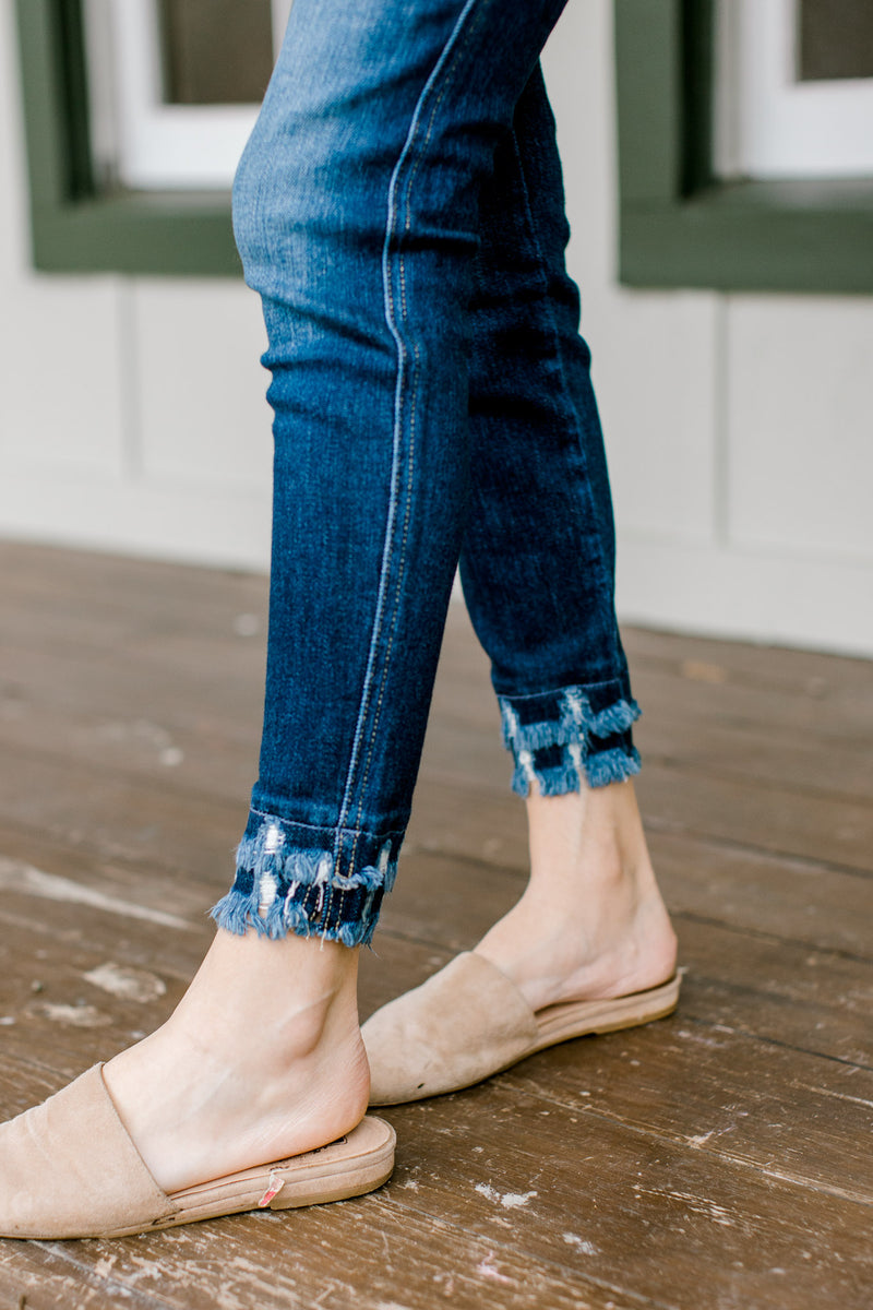 Close up of Model wearing double fray hem skinny jeans.