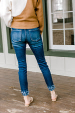 Back view of Model wearing double fray hem skinny jeans.