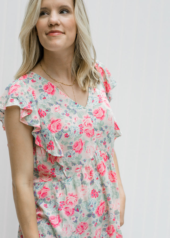 Blonde model wearing a pink floral babydoll top.