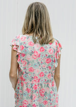 Back view of Blonde model wearing a pink floral babydoll top.