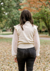 BAck view of Brunette model wearing ivory colored sweater with lacework sleeves.
