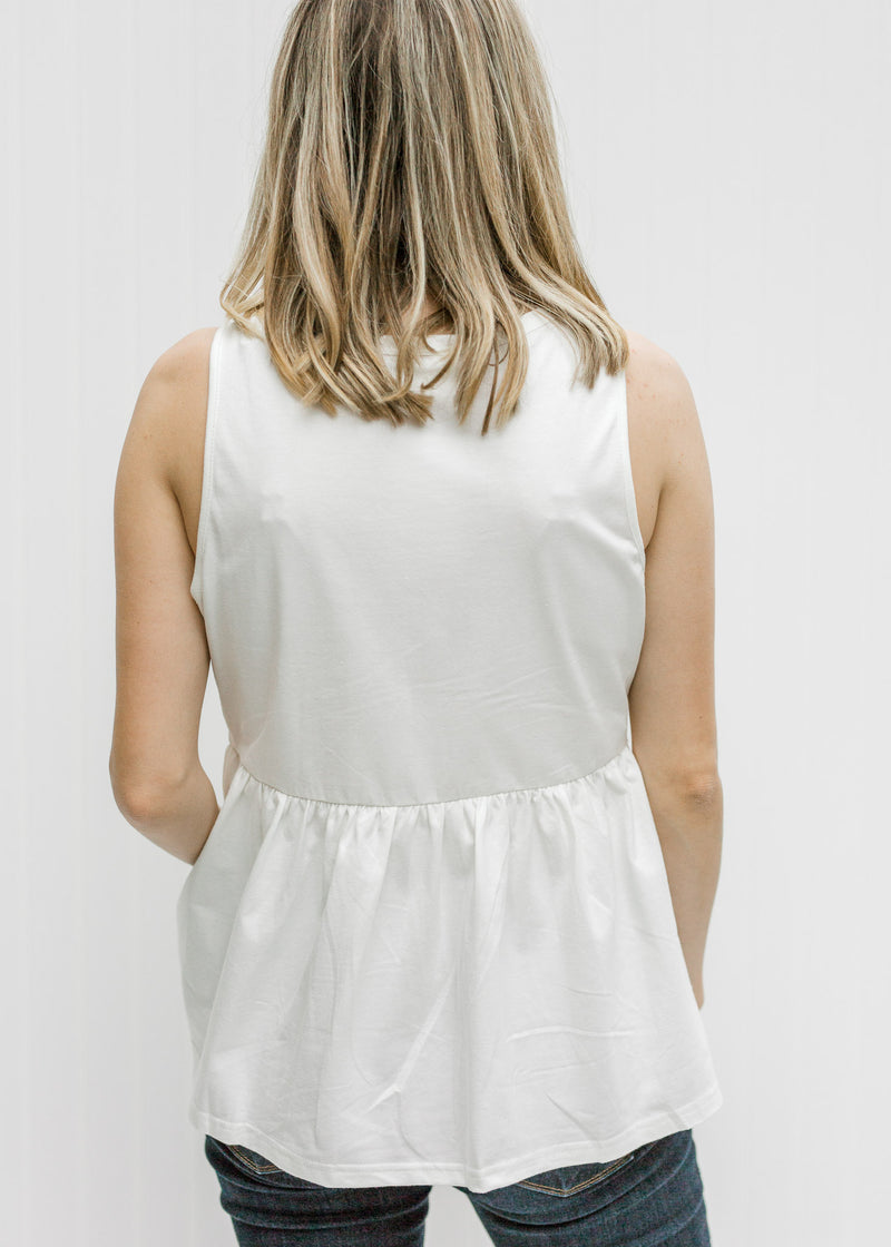Back view of  Blonde model wearing a white tank with Aztec embroidery