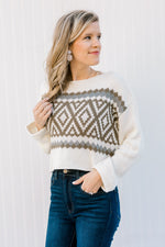Blonde model wearing a nordic sweater with a crop hem.